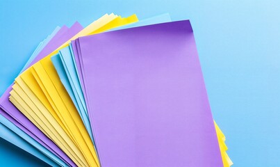 Vibrant Pastel Paper Fan Composition on Soft Blue Background for Creative Inspiration.