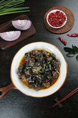 Thai Black Chicken and Mushroom Stir-Fry with Fresh Ingredients and Spices on Dark Wood Background