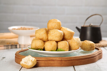 Golden Fried Tofu Puffs Hollow Crispy Asian Appetizer on Wooden Board
