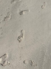 footprints in sand on the ocean beach