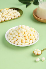 Fresh White Corn Puffs Cereal Bowl with Milk - Healthy Breakfast Food on Green Background
