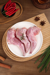 Raw Rabbit Meat Forelegs with Spices and Herbs for Asian Sichuan Cooking on Wooden Board