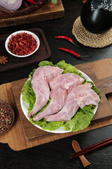Raw rabbit foreleg meat with Sichuan spices and chilies for traditional Chinese cuisine cooking preparation