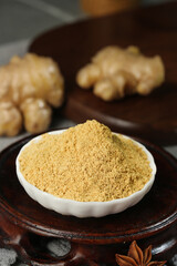 Ground Ginger Powder Spice in Bowl with Fresh Ginger Root - Natural Seasoning for Cooking and Health