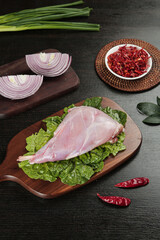 Raw Rabbit Foreleg Meat with Vegetables and Sichuan Spices on Wooden Board for Asian Cooking