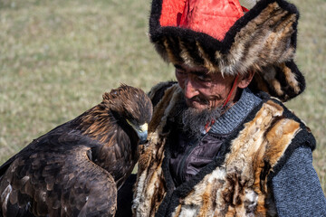 A Mongolian eagle hunter, a berkutchi, prepares to hunt with his bird on a September day in Mongolia.