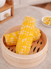Fresh Sweet Corn Cobs in Wooden Steamer Basket - Golden Yellow Kernels Ready for Cooking
