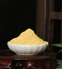 Fresh Ground Ginger Powder Spice in White Bowl - Healthy Yellow Seasoning Ingredient