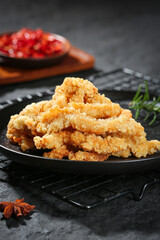 Crispy Fried Chicken Strips on Cast Iron Skillet - Golden Brown Breaded Meat Snacks