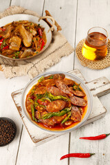 Handmade Spicy Sichuan Sausage Dishes in Farmhouse Style Bowls with Tea on Rustic White Wood Table