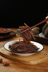 Pickled Turnip Vegetables with Chopsticks - Traditional Chinese Food Preparation on White Plate