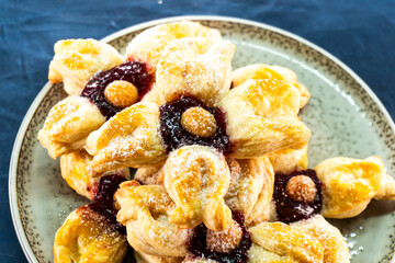 Puff pastry flower with raspberry jam filling. Baked goods. Desserts. Food concept.