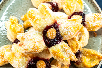 Puff pastry flower with raspberry jam filling. Baked goods. Desserts. Food concept.