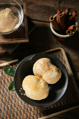 Lion's Mane Mushrooms in Black Bowl with Cinnamon Sticks on Rustic Wooden Table