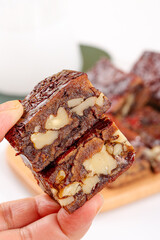 Xinjiang Date Jujube Cake Chinese Traditional Snack with Nuts Hand Held Close Up