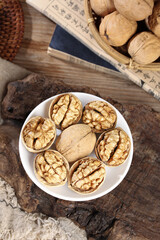 Fresh Walnuts on Rustic Wood Table with Chinese Newspaper and Basket - Healthy Nuts Snack Food Photography