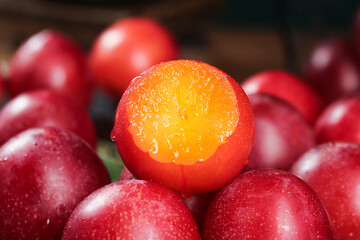 Fresh Red Plums Cut in Half Showing Golden Flesh - Healthy Stone Fruit