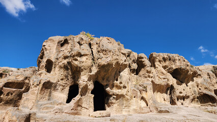 The rock-carved ancient cave houses in the ancient settlement surrounding G&uuml;m&uuml;şler Monastery in Nigde Turkey.