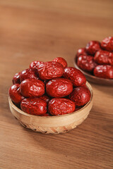 Xinjiang Hetian Red Jujubes in Bamboo Bowls - Premium Chinese Dried Dates on Wood Background