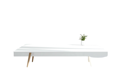 Low, rectangular white coffee table with slightly curved edges and four light wood tapered legs; small potted plant sits atop