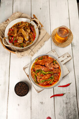 Handmade Spicy Sichuan Sausage Dishes with Tea on Rustic White Wooden Table - Traditional Chinese Cuisine