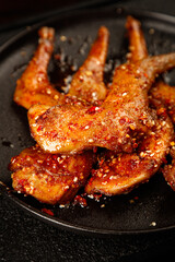 Spicy Sichuan Roasted Rabbit Legs with Chili Oil and Sesame Seeds in Cast Iron Pan