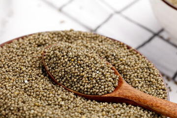 Organic Millet Grains in Wooden Spoon - Healthy Gluten-Free Cereal Seeds for Natural Nutrition