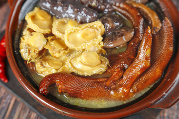 Chinese Hot Pot with Dumplings and Sausages in Traditional Clay Pot Asian Cuisine