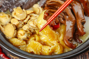 Asian Hot Pot with Mushrooms and Noodles - Traditional Oriental Cuisine with Chopsticks