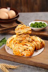 Homemade Savory Meat and Pastry Rolls with Fresh Herbs on Wooden Cutting Board