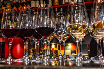 Glasses of red and white wine on the table
