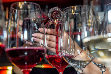 When pouring red wine into a glass