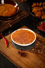 Spicy Red Chili Powder in Bowl with Star Anise and Dried Chilies for Hot Pot Base and Asian Cooking