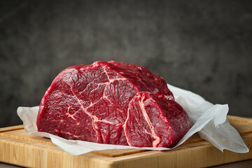 fresh raw beef meat with on wooden cutting board
