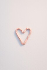 Fototapeta premium Candy Cane Heart on Snow Heart-Shaped Candy Cane Design on Soft Background for Holidays