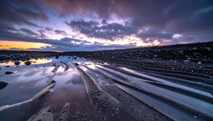 Cinematic glacial landscape of an outwash braid at twilight from ground level, polished gravel reflecting a bruised sky for serene depth.