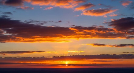 Obraz premium Dramatic sunset over a horizon, featuring vibrant orange and blue hues