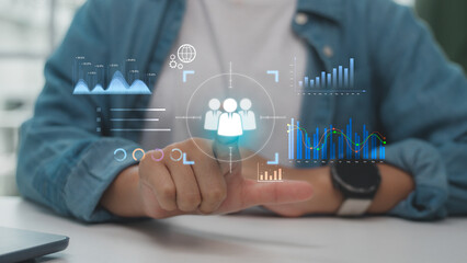 Hand pointing at digital interface with target icon and data analytics graphs, representing customer targeting, data-driven strategy, and business intelligence technology.