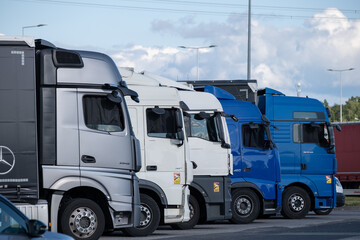 Row of parked trucks in a logistics parking area © Nataliia