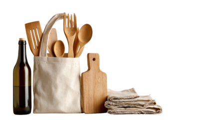 Natural kitchen tools in a canvas bag.  Wooden utensils, cutting board, and a bottle in a simple tote