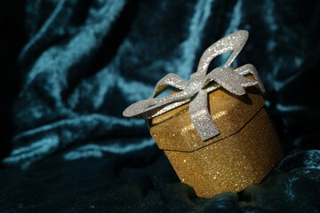 Shiny gift box on a glamorous velvet background
