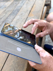Hands vitiligo male browsing social media.