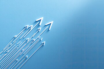 Abstract graphic of multiple white arrows radiating outward on a light blue background