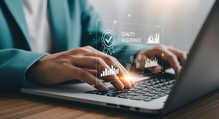 Hands typing on laptop focusing on Quality Assurance badge and digital charts overlay Technology business process