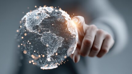 A hand interacts with a glowing digital globe made of networked points and lines, symbolizing global connectivity and technology.