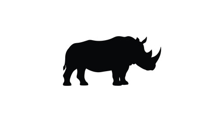 A striking black rhino stands powerfully presented as a dramatic silhouette