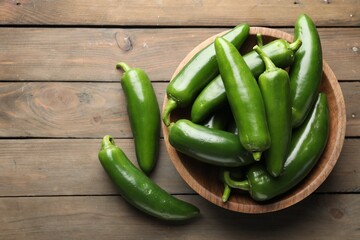 Fresh jalapeno peppers on wooden table, top view. Space for text