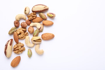 Mix of different nuts on white background, flat lay. Space for text
