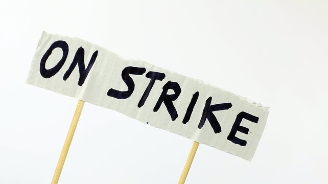 On Strike Close-up of text on paper white background end copy space.
