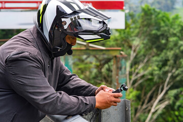 Man wearing helmet taking video and photo in outdoor. Private investigator concept.